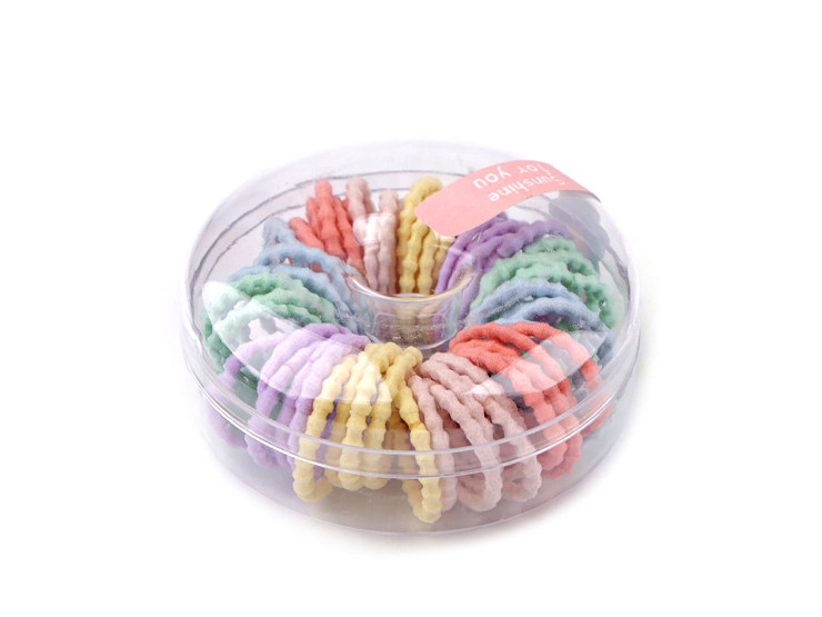 Élastiques à cheveux dans une boîte en forme de beignet